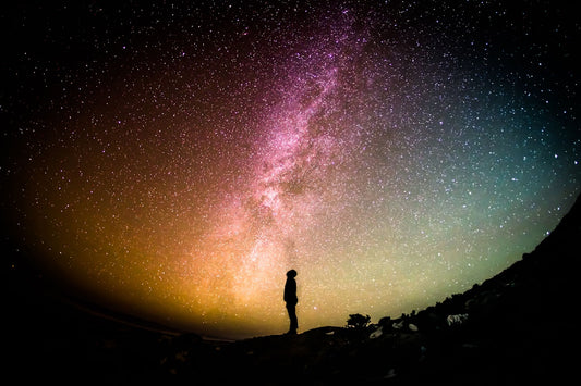 Brilliant Milky Way arching over a dark landscape — astronomy gifts that arrive before Christmas