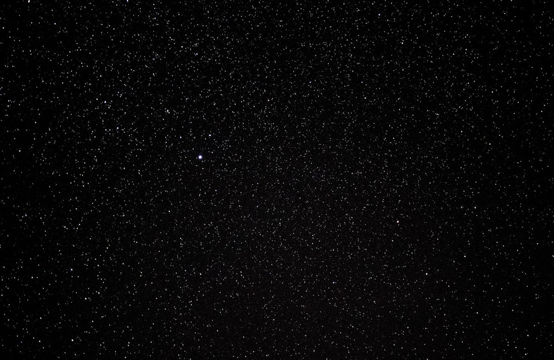 Bright meteor streaking across a dark winter night sky during the Geminid meteor shower