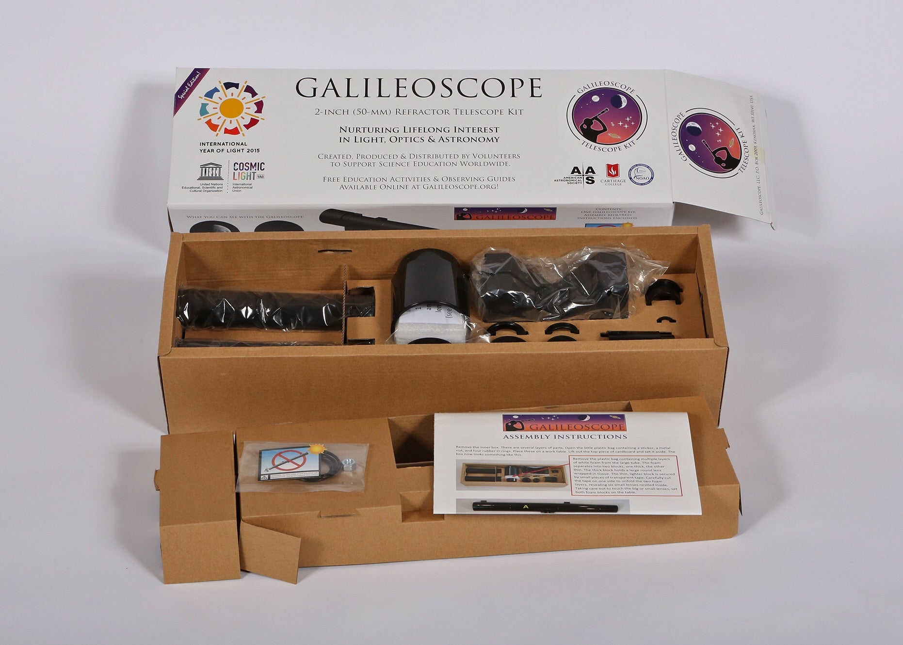 Explore Scientific Galileoscope educational telescope kit GSCOPE open box view revealing all components neatly organized and ready for assembly confirming everything needed to build a complete 50mm refractor telescope is included out of the box for kids students and beginner astronomers — Telescope Wolves
